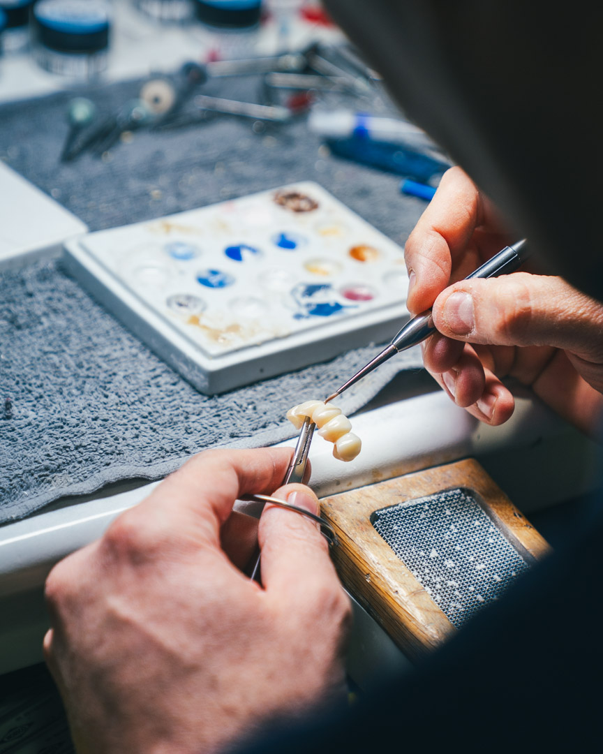 Dental technician working on ceramic in the laboratory